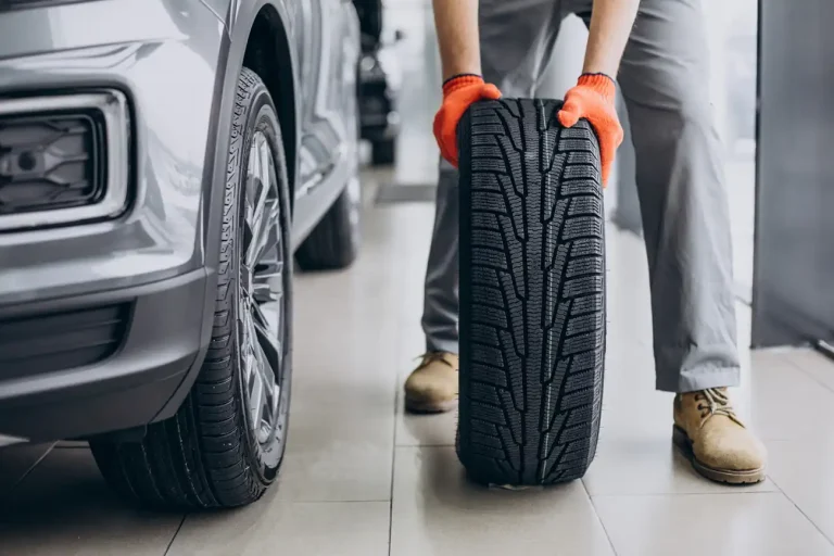 mechanic-changing-tires-car-service-768x512